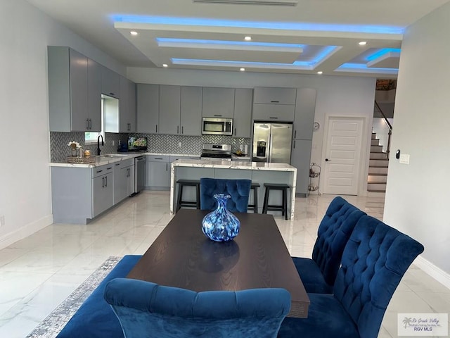 dining area with recessed lighting, baseboards, stairs, marble finish floor, and a raised ceiling