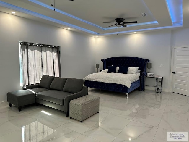 bedroom featuring visible vents, baseboards, a raised ceiling, ceiling fan, and marble finish floor