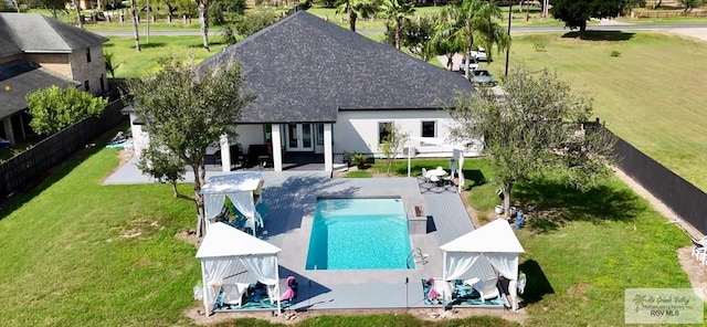 exterior space featuring a gazebo, a fenced backyard, a lawn, and french doors