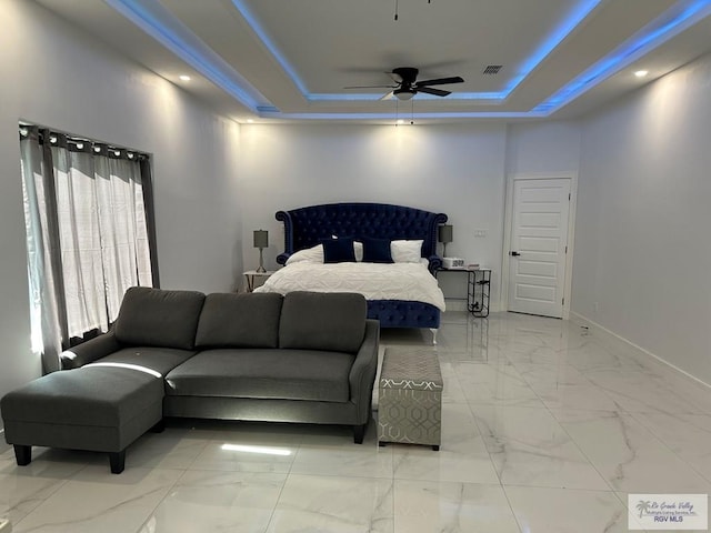 bedroom with visible vents, baseboards, a raised ceiling, ceiling fan, and marble finish floor