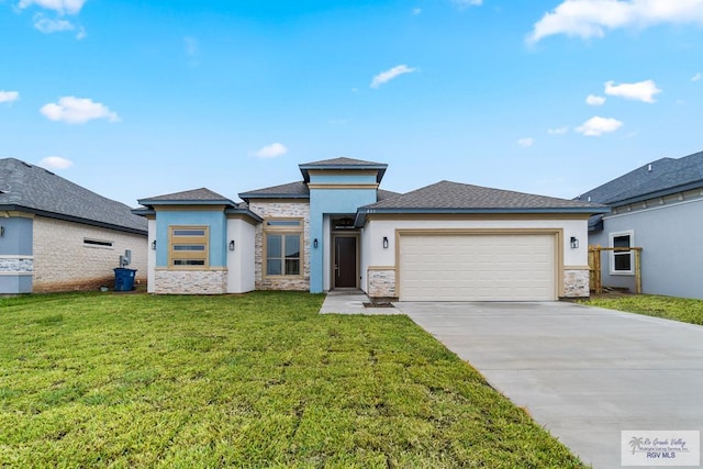 prairie-style house featuring a garage and a front yard