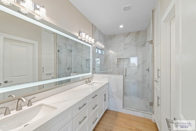 bathroom with vanity, hardwood / wood-style floors, and an enclosed shower