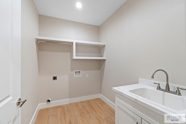 clothes washing area with sink, electric dryer hookup, cabinets, washer hookup, and light hardwood / wood-style floors