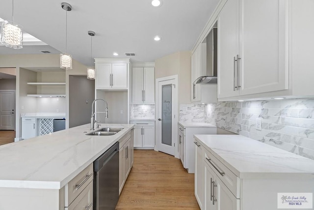 kitchen with white cabinetry, sink, dishwasher, and a center island with sink