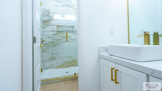 bathroom featuring vanity, hardwood / wood-style floors, and an enclosed shower