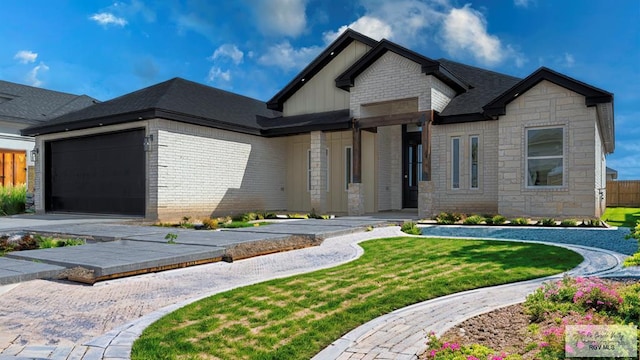 view of front of property featuring a garage and a front lawn