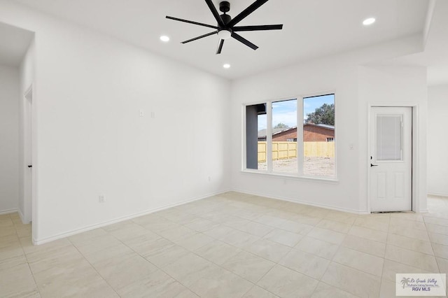 tiled empty room featuring ceiling fan