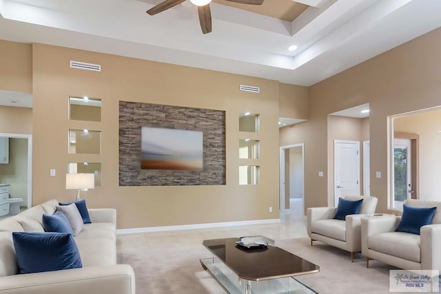 living room featuring ceiling fan, a towering ceiling, and light tile patterned floors