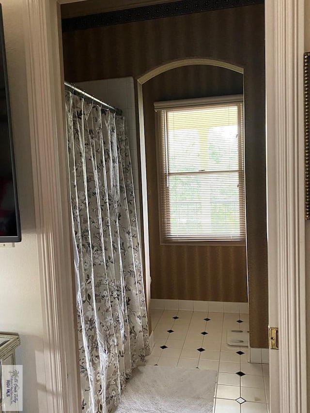 bathroom featuring a shower with shower curtain and tile patterned floors