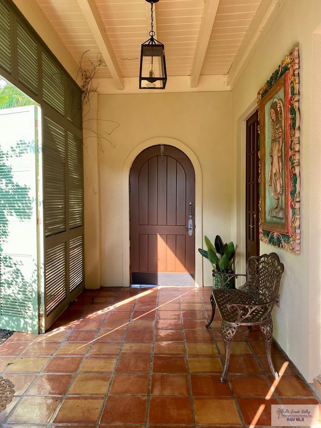 view of exterior entry with covered porch