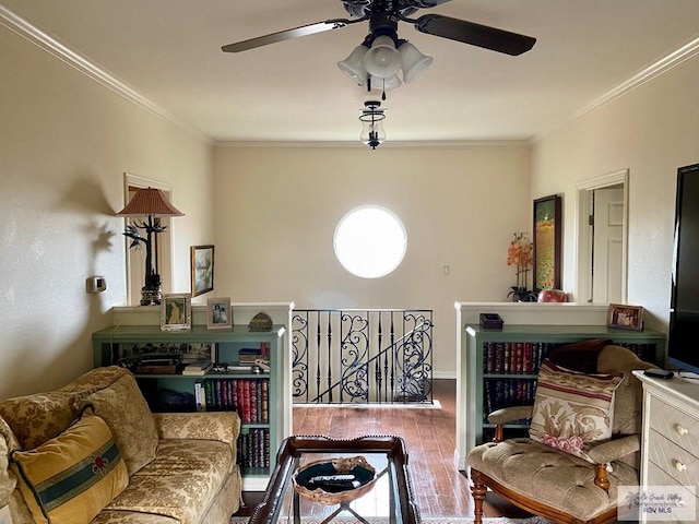 sitting room featuring ornamental molding, wood finished floors, and an upstairs landing