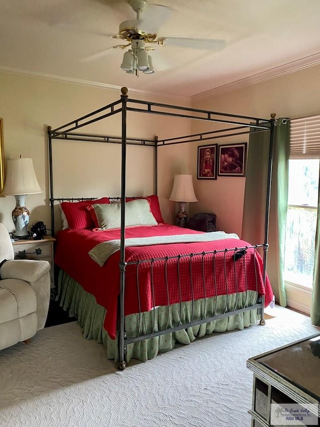 bedroom with carpet floors, ornamental molding, and a ceiling fan