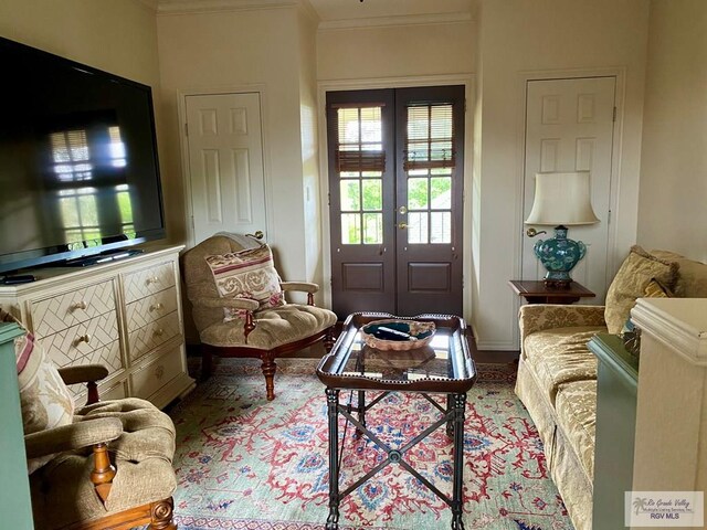 sitting room featuring crown molding and french doors