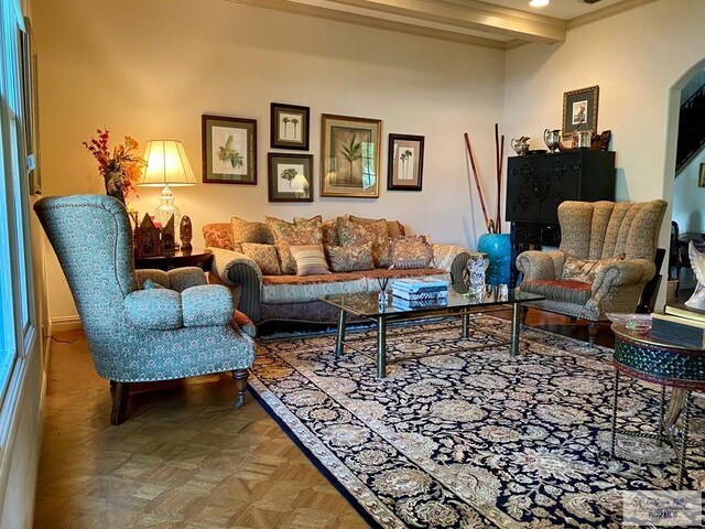 living room with beamed ceiling, parquet floors, and ornamental molding