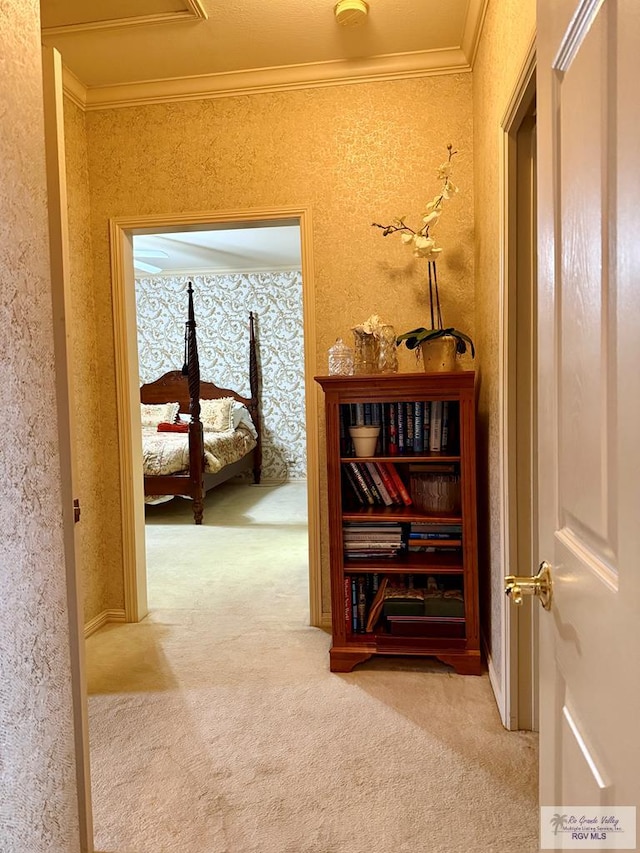 corridor with carpet floors and ornamental molding