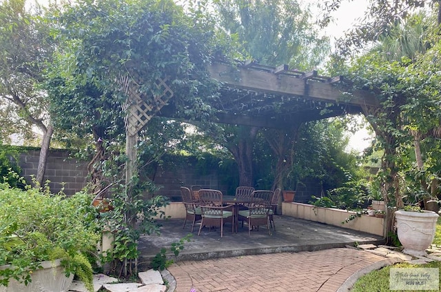 view of patio / terrace featuring fence, outdoor dining area, and a pergola