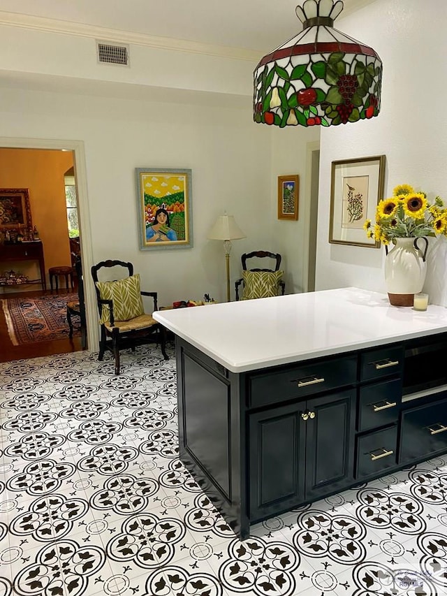 kitchen with ornamental molding, light countertops, visible vents, and light tile patterned floors