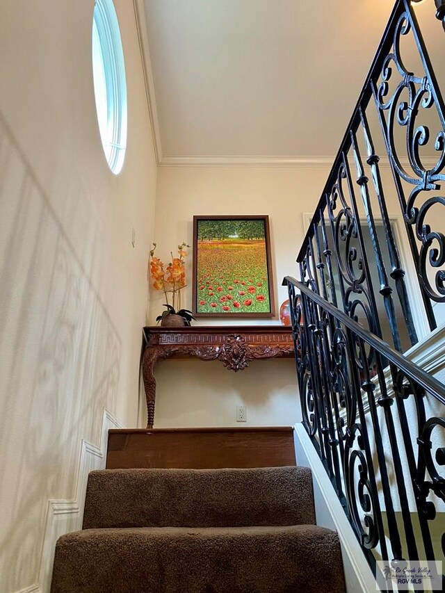 stairs featuring crown molding