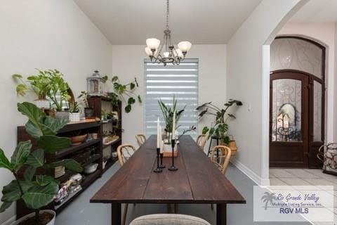 dining area with an inviting chandelier and light tile patterned floors