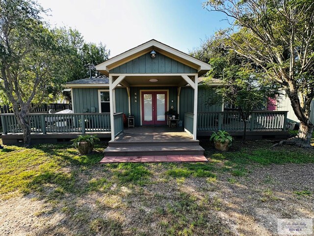 view of front of house with a wooden deck and french doors