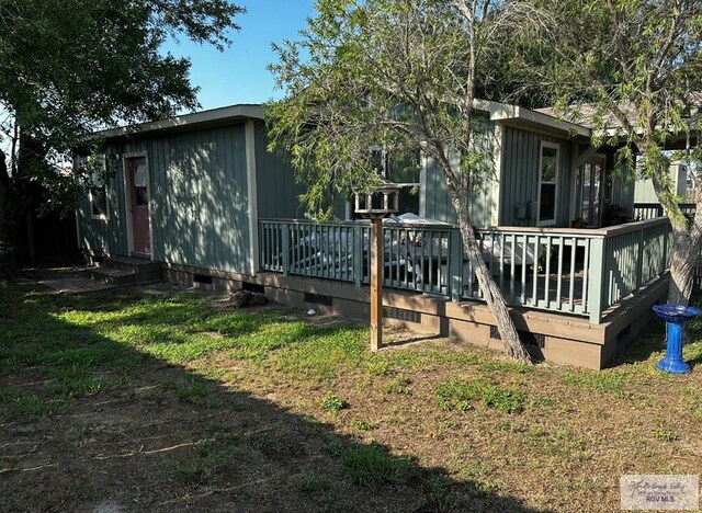 rear view of house with a yard