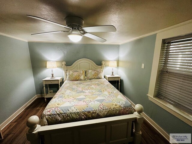 bedroom with a textured ceiling, ceiling fan, dark hardwood / wood-style floors, and ornamental molding