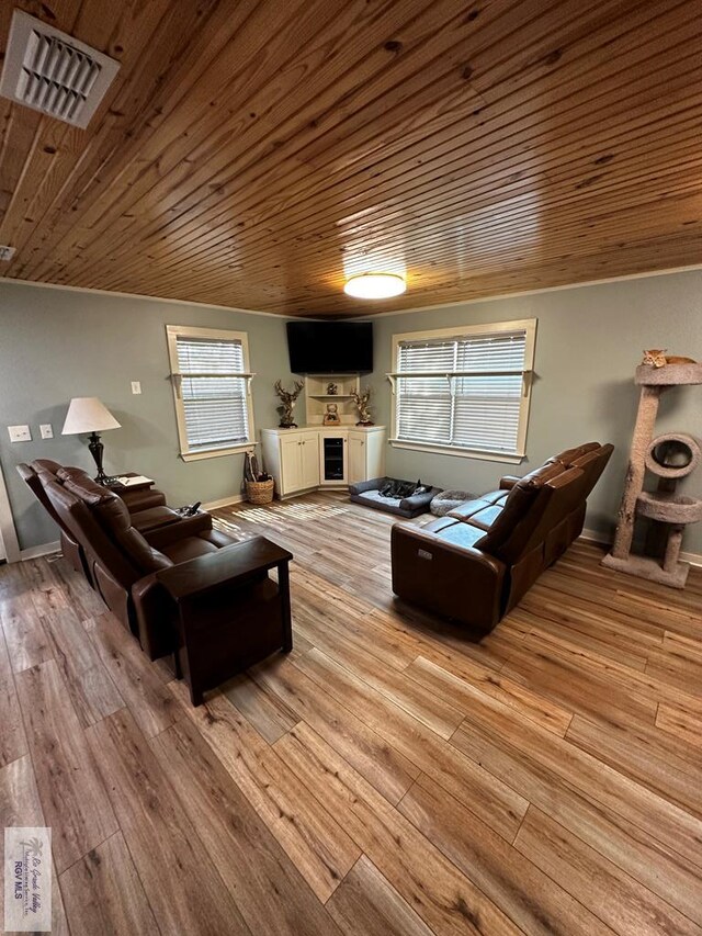 living room featuring light hardwood / wood-style flooring and wood ceiling