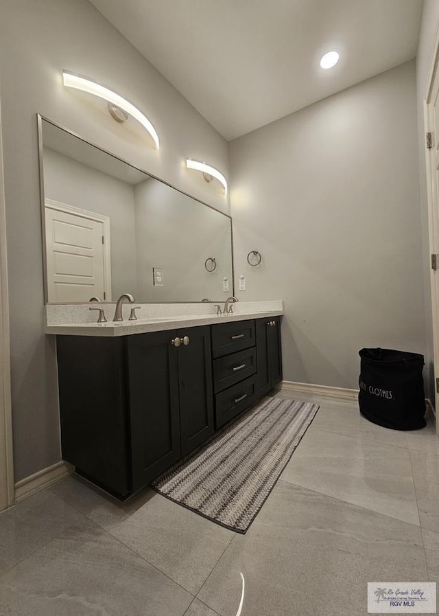 bathroom with tile patterned flooring and vanity