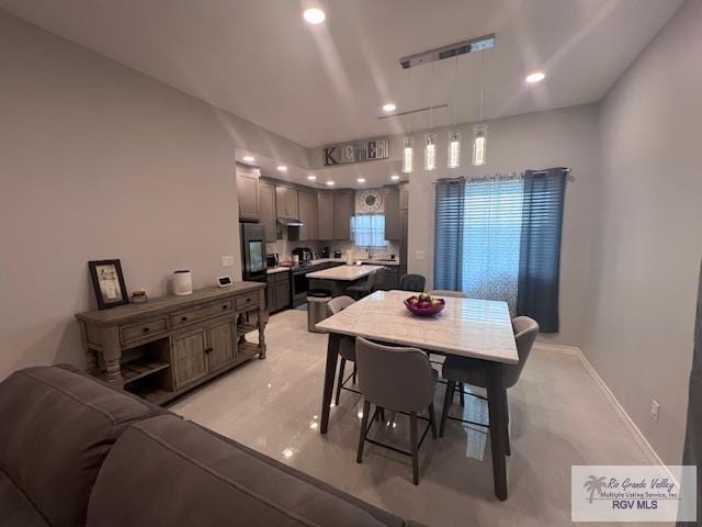 dining area with recessed lighting and baseboards