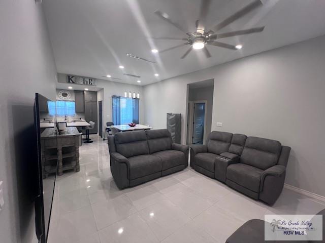 living area featuring a ceiling fan, recessed lighting, and baseboards