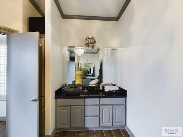 bathroom with vanity, hardwood / wood-style flooring, and ornamental molding