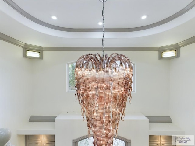 room details featuring a tray ceiling and a chandelier