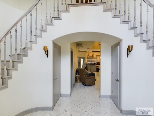 stairway featuring tile patterned flooring