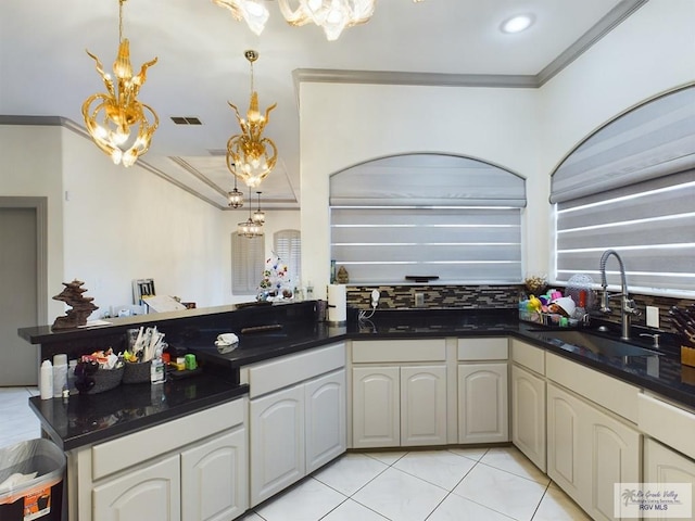 kitchen with an inviting chandelier, hanging light fixtures, crown molding, and sink