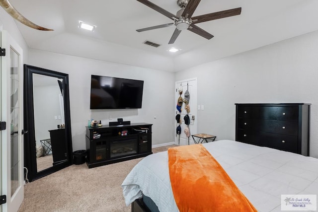 bedroom featuring vaulted ceiling, a ceiling fan, visible vents, and light colored carpet