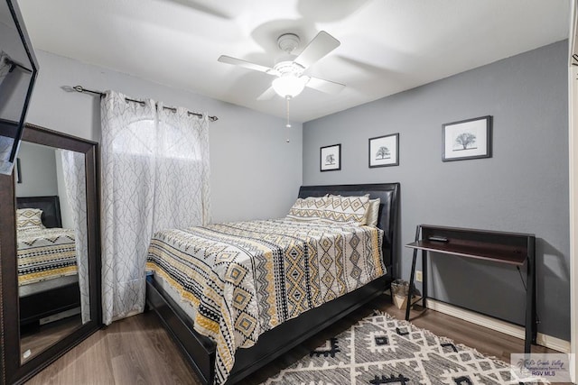 bedroom featuring ceiling fan, baseboards, and wood finished floors