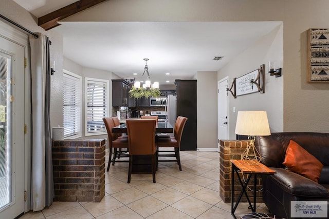 dining room with light tile patterned floors, visible vents, a chandelier, and beam ceiling