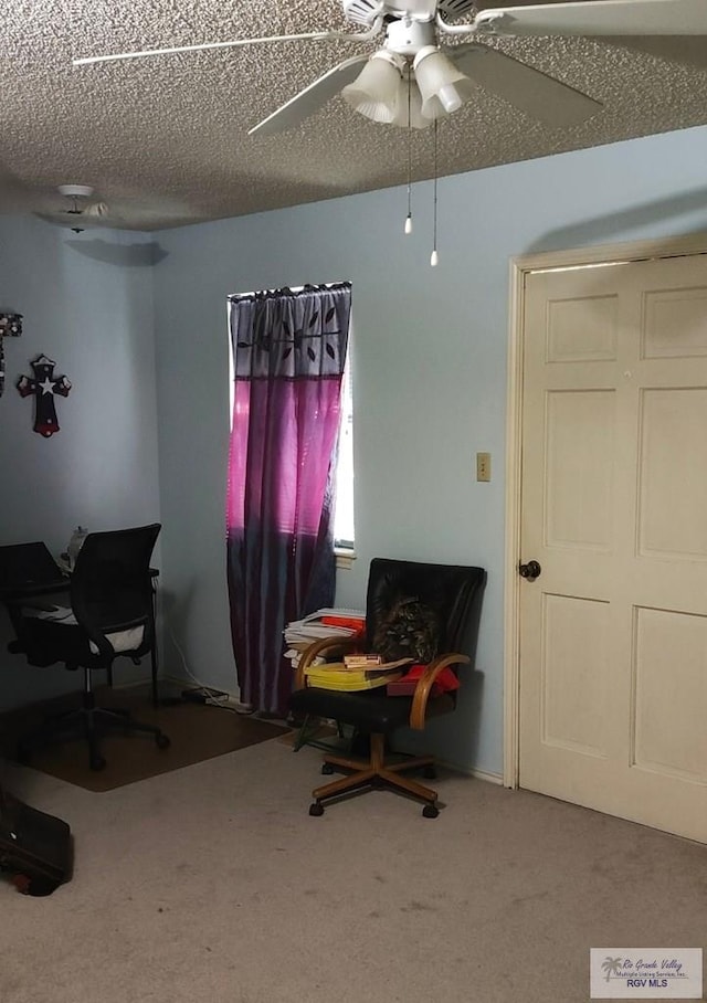 office with a ceiling fan, carpet flooring, and a textured ceiling