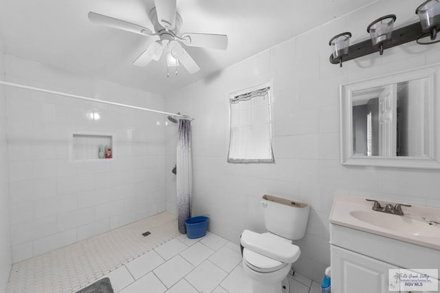 bathroom with toilet, vanity, tile patterned floors, and curtained shower