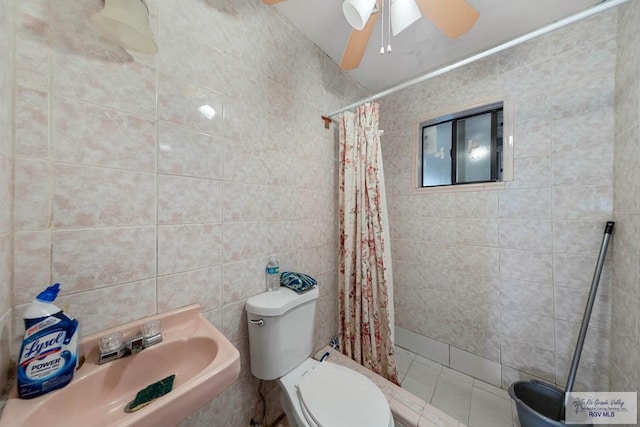 bathroom with a shower with curtain, sink, tile walls, and toilet