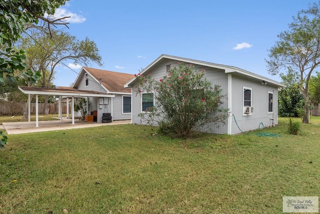 back of house with a lawn, cooling unit, and a patio