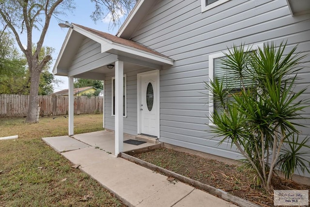 entrance to property featuring a yard