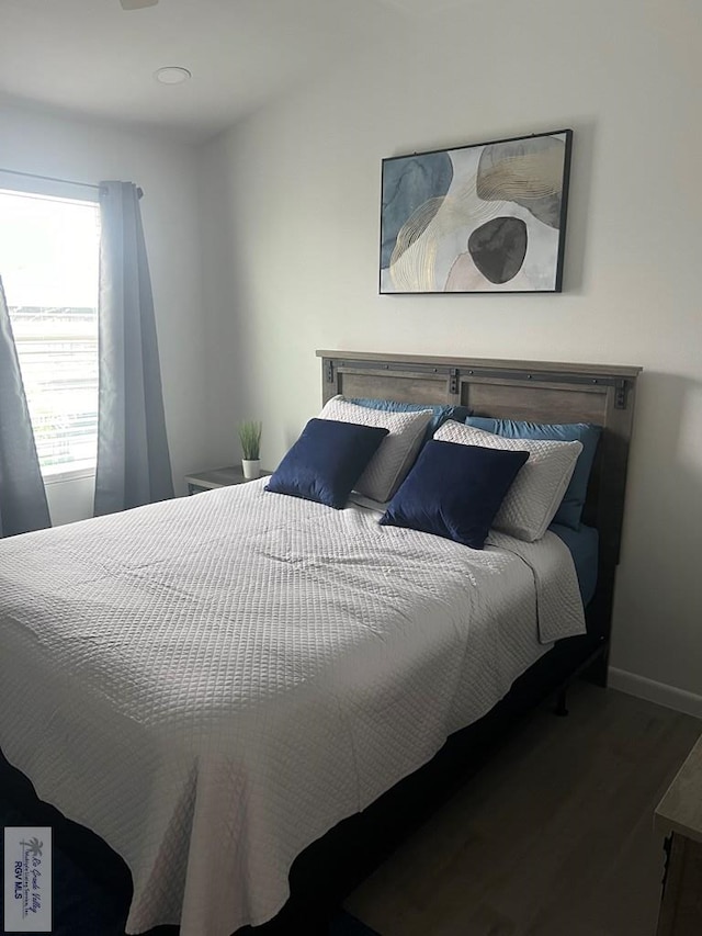 bedroom with hardwood / wood-style flooring