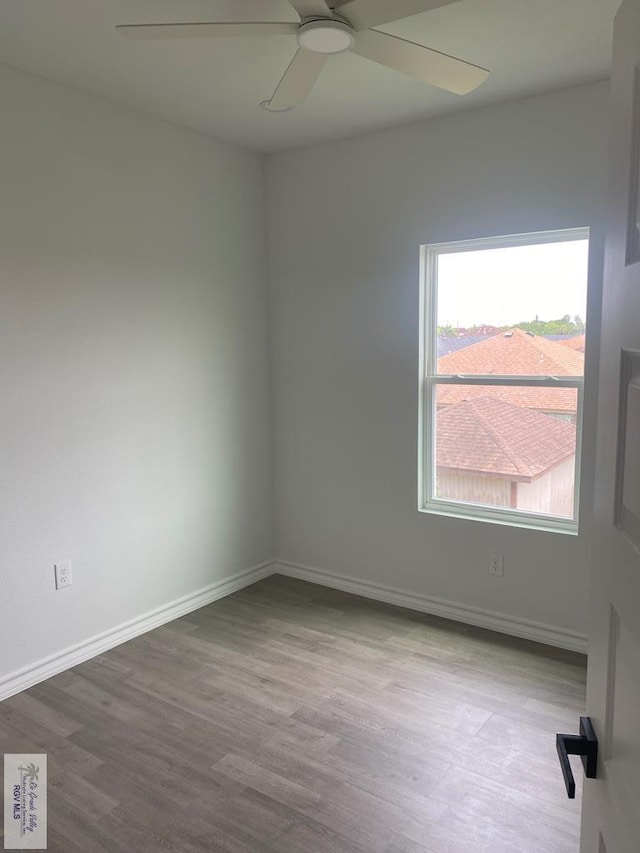 empty room with ceiling fan and light wood-type flooring