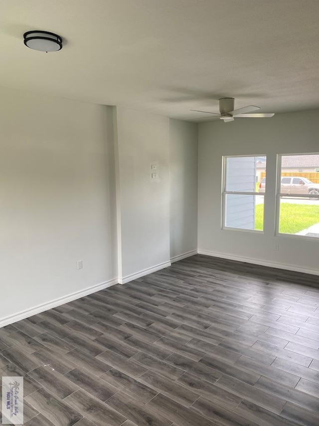 unfurnished room with dark hardwood / wood-style flooring and ceiling fan