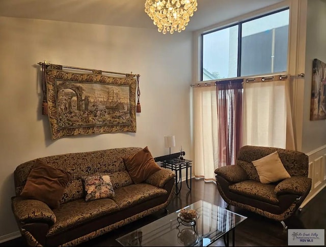 living area featuring a chandelier and wood-type flooring