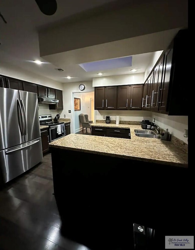 kitchen with kitchen peninsula, dark brown cabinetry, sink, and appliances with stainless steel finishes