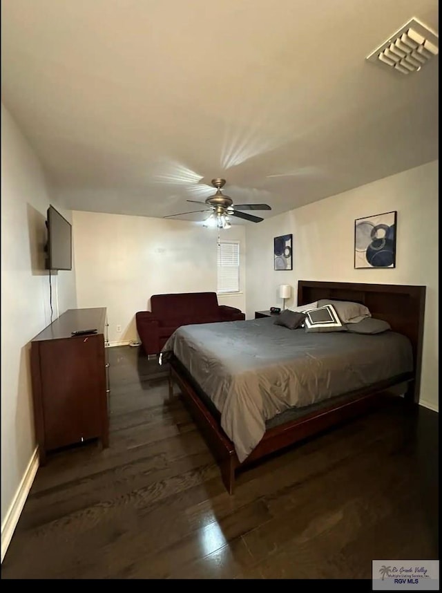 bedroom featuring ceiling fan and dark wood-type flooring