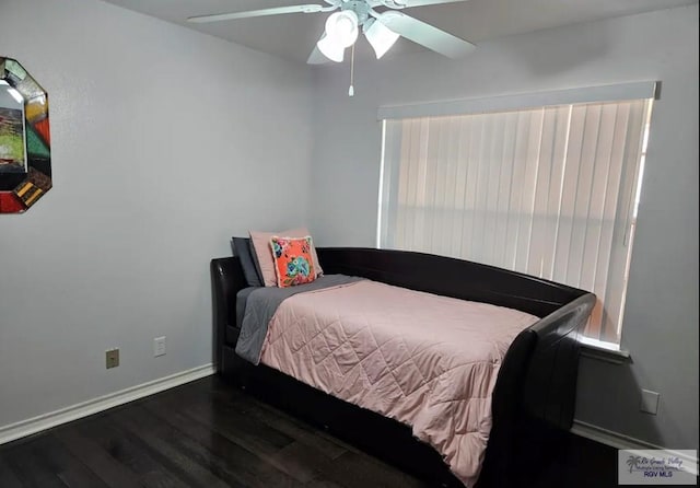 bedroom with ceiling fan and dark hardwood / wood-style floors