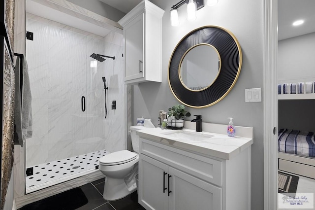 bathroom with tile patterned floors, vanity, an enclosed shower, and toilet